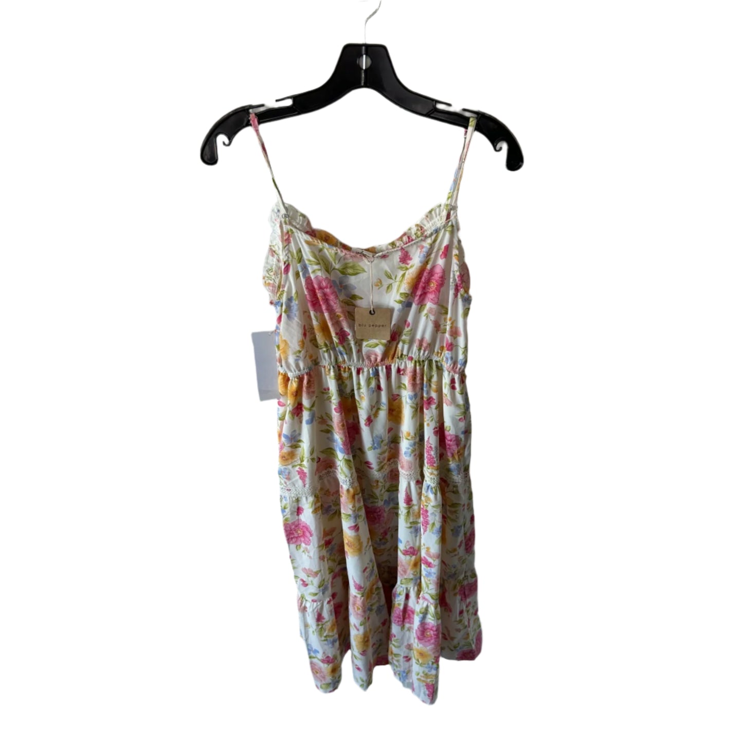 Floral dress on a hanger against a white brick wall